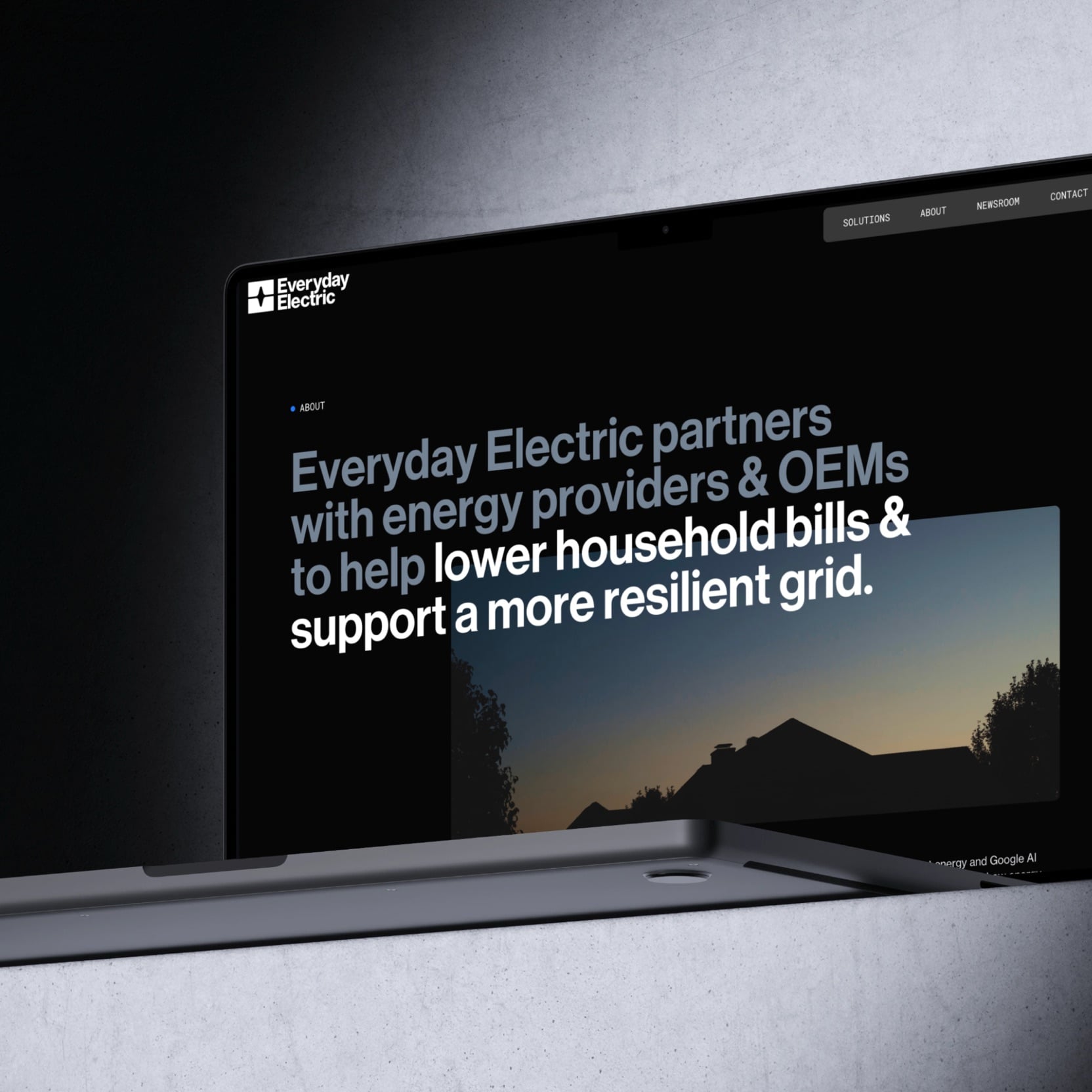 Laptop showing the Everyday Electric about page: "Everyday Electric partners with energy providers & OEMs to help lower household bills & support a more resilient grid", over a photo of a house at dusk